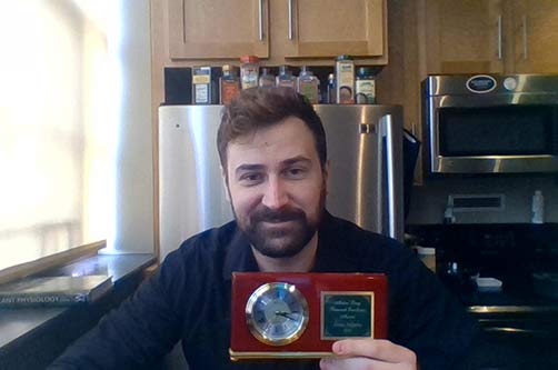 Evan Angelos with his award clock