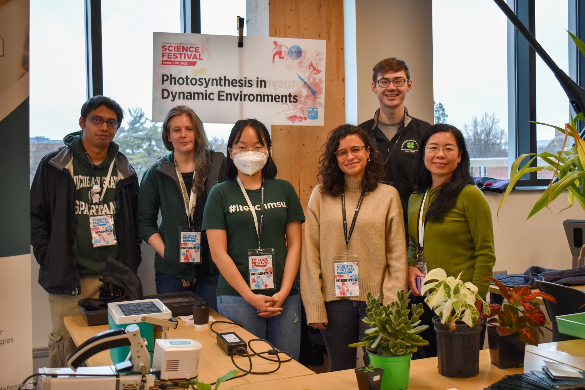 The Community Building and Outreach Committee and volunteers at their booth, "Photosynthesis in Dynamic Environments." Left to right, Daipayan Sarkar, Deserah Strand, Huijia Gong, Liana Acevedo Siaca, Max Harman and Jinjie Liu.