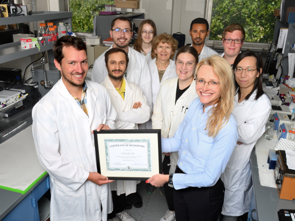 Walker lab members are presented with a certificate