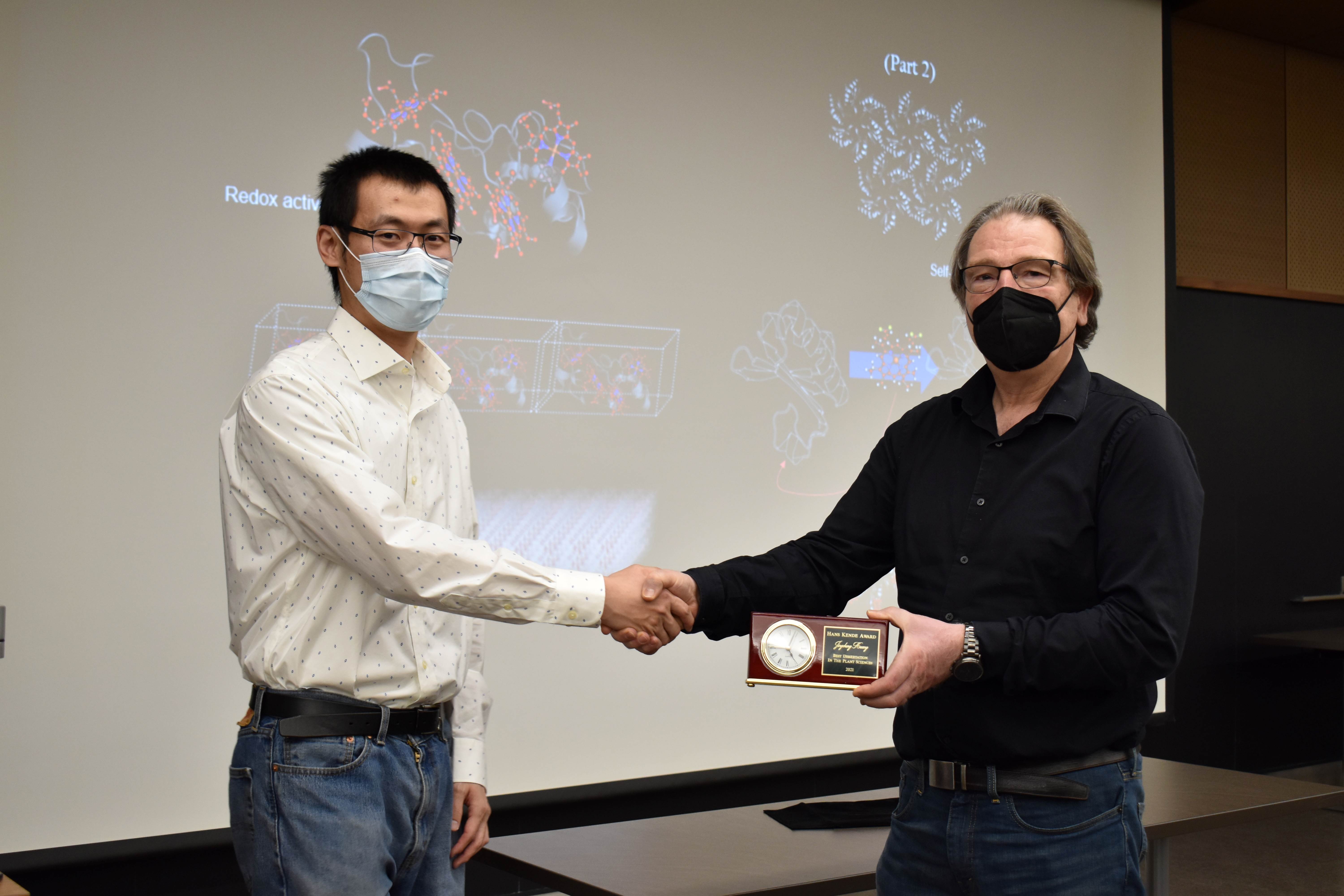 Jingcheng Huang and Christoph Benning shake hands