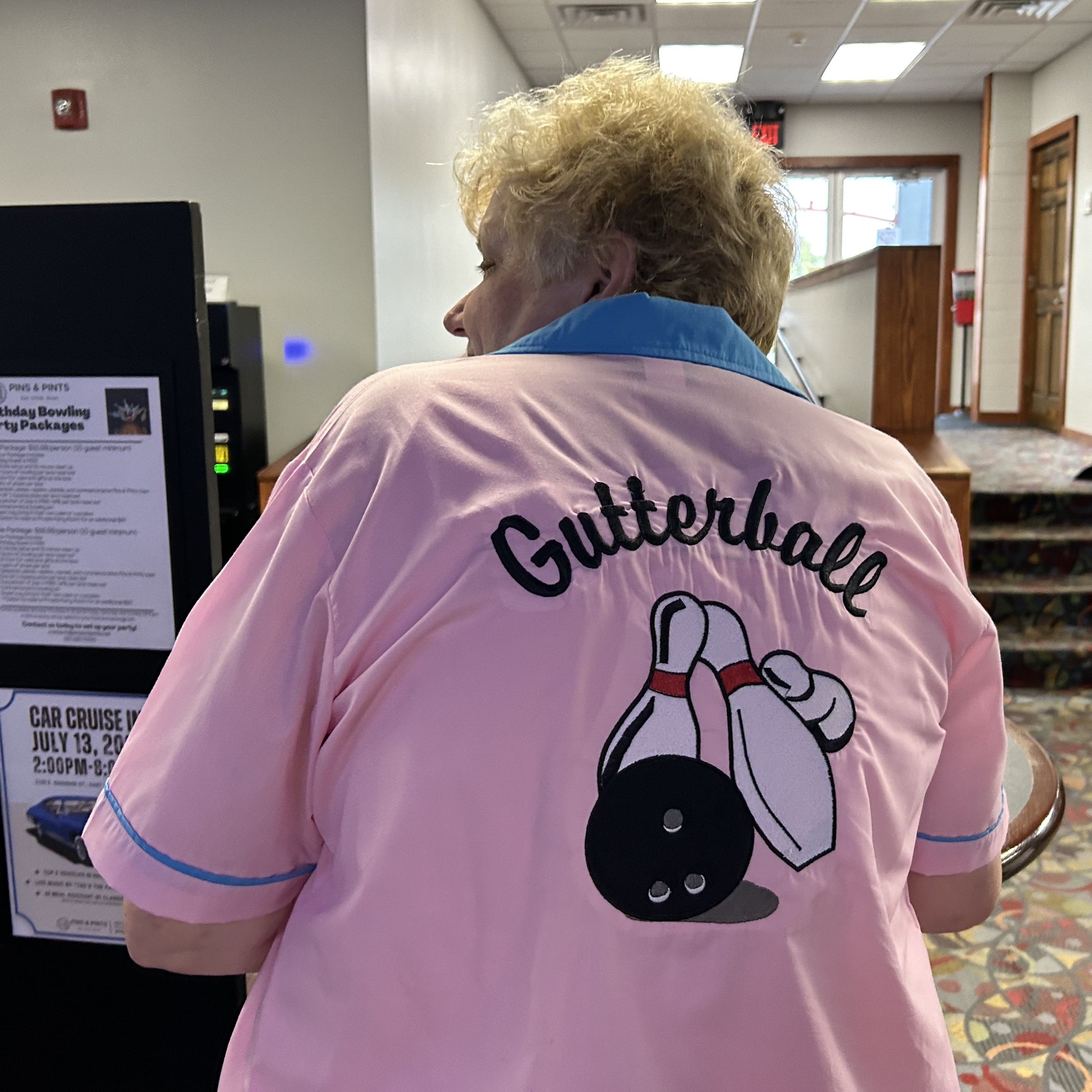 The back of a shirt. It reads Gutterball, and has bowling pins and a bowling ball depicted